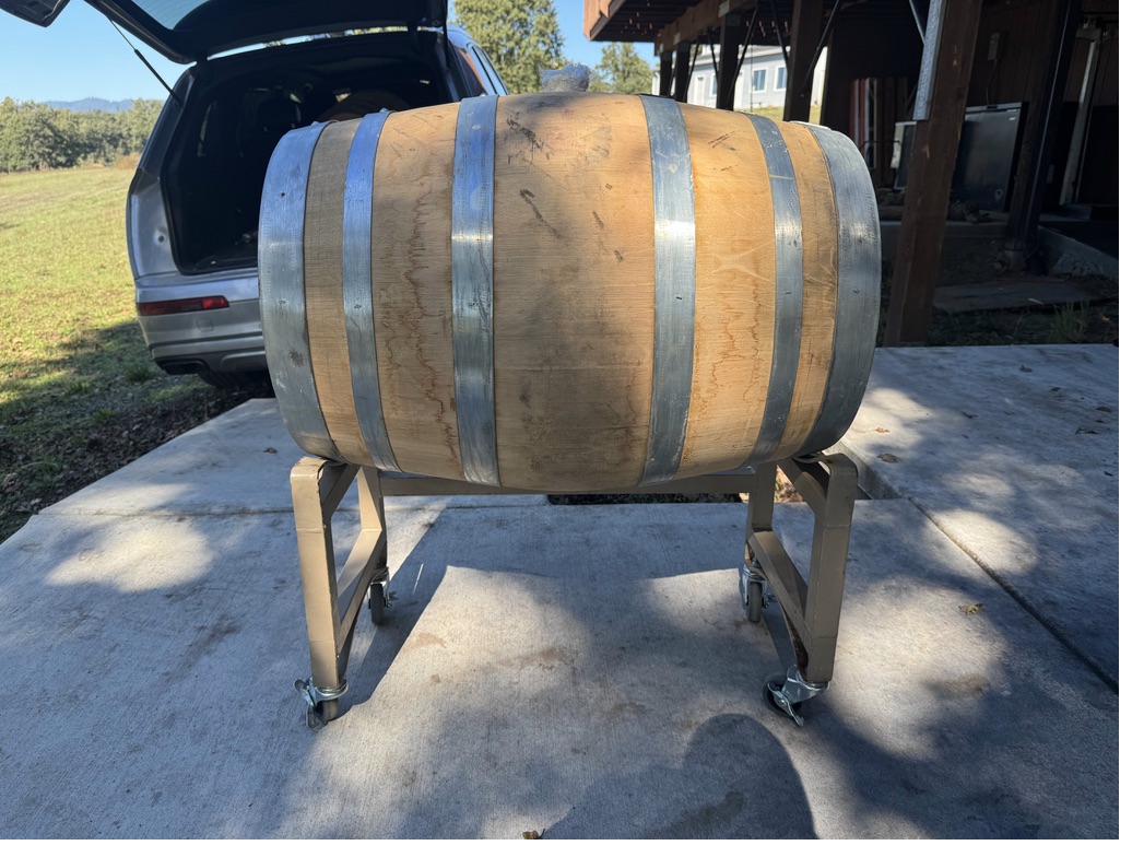 Oak barrel on a rolling stand outdoors